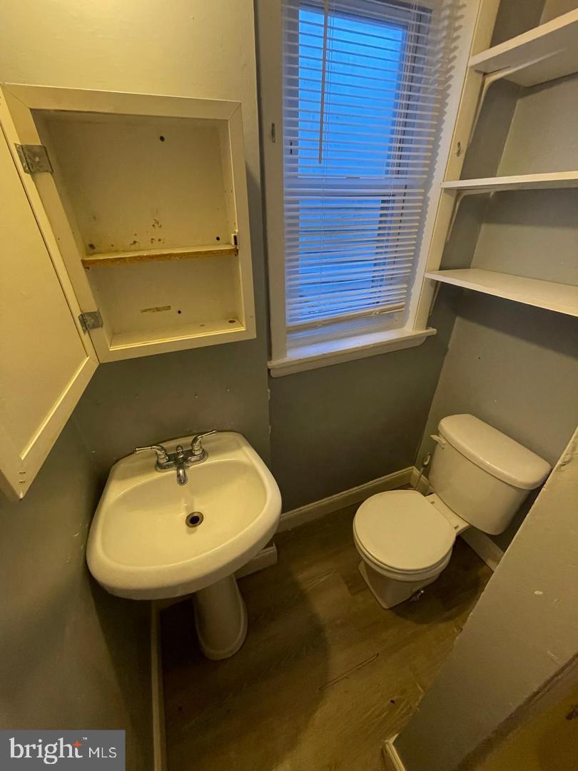 1124 Thomas Street Chester, PA 19013 - Photo 11 of 11 a bathroom with a sink toilet and mirror