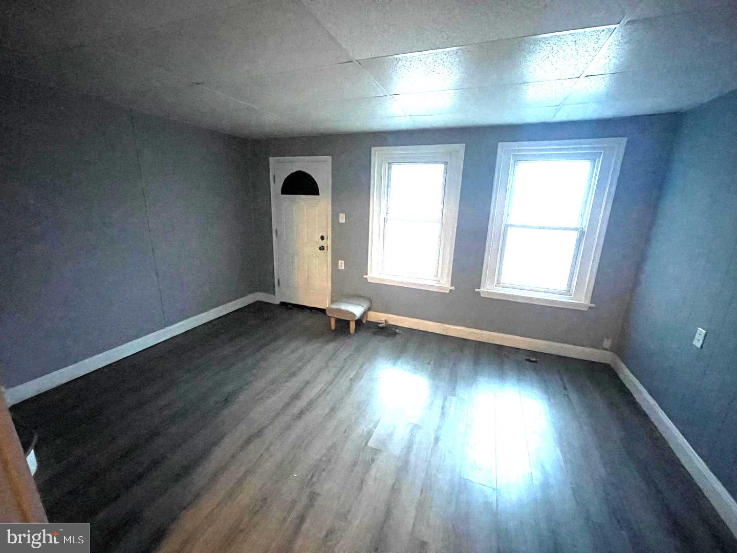 1124 Thomas Street Chester, PA 19013 - Photo 2 of 11 an empty room with wooden floor and windows