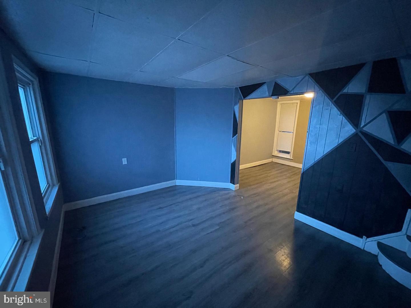 1124 Thomas Street Chester, PA 19013 - Photo 3 of 11 a view of an empty room with wooden floor and a window