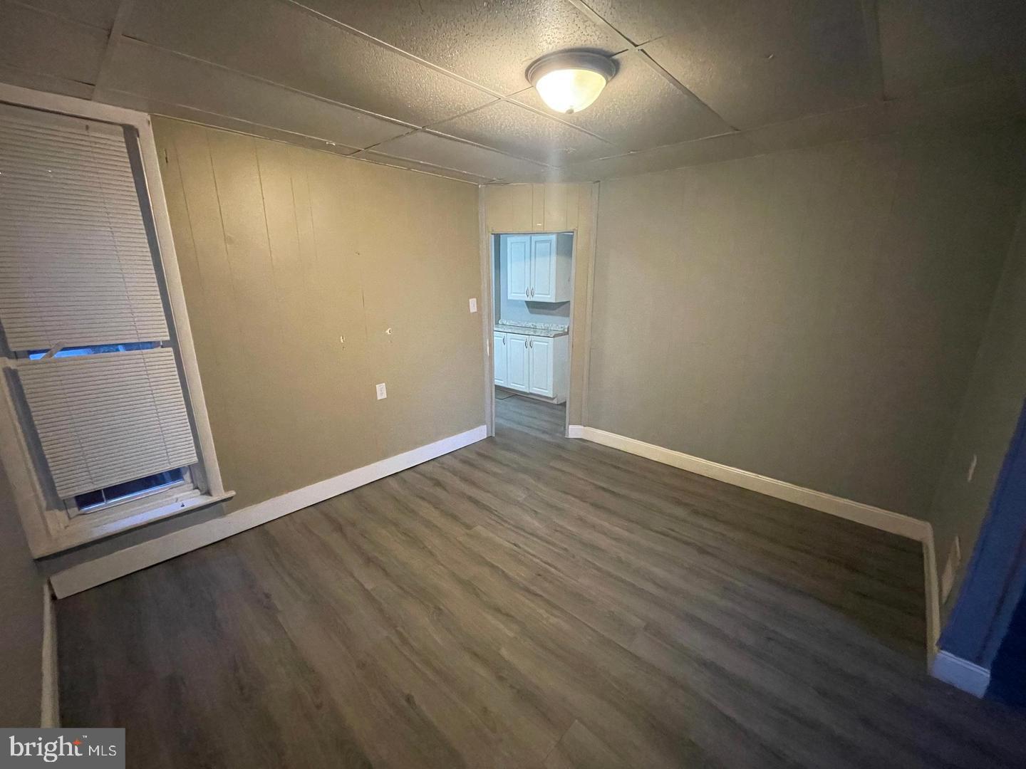 1124 Thomas Street Chester, PA 19013 - Photo 4 of 11 an empty room with wooden floor and entrance