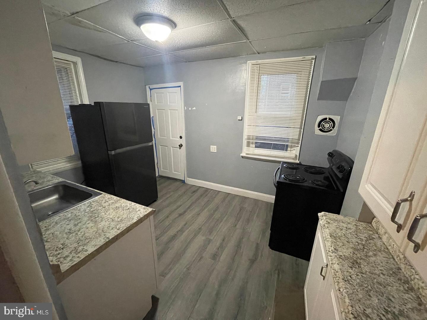 1124 Thomas Street Chester, PA 19013 - Photo 5 of 11 a view of kitchen with cabinets and wooden floor