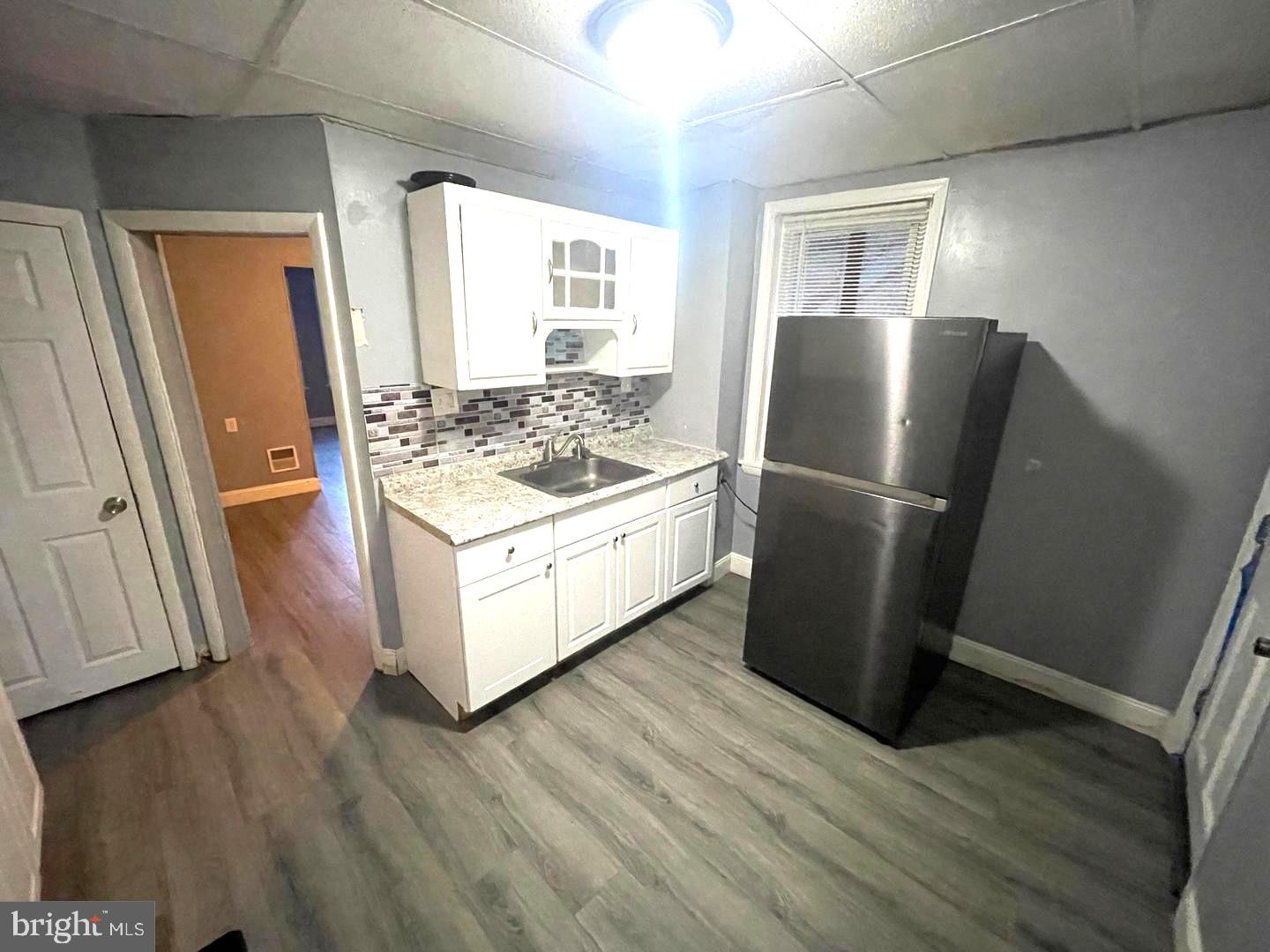 1124 Thomas Street Chester, PA 19013 - Photo 6 of 11 a kitchen with stainless steel appliances a refrigerator and wooden floor