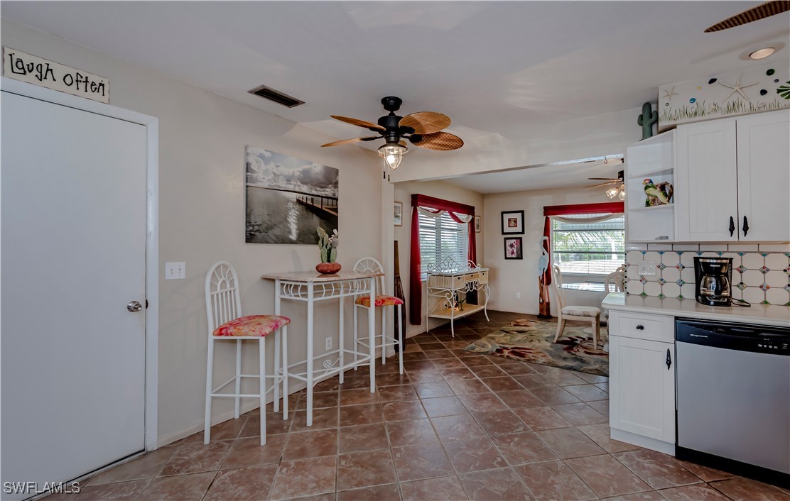 12101 Moon Shell Drive Matlacha Isles, FL 33991 - Photo 12 of 42 a living room with furniture a flat screen tv and kitchen view