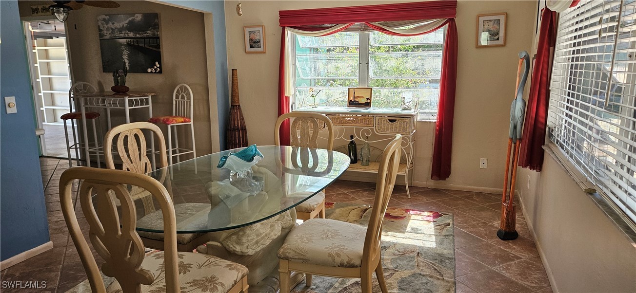 12101 Moon Shell Drive Matlacha Isles, FL 33991 - Photo 14 of 42 a dining room with furniture and windows