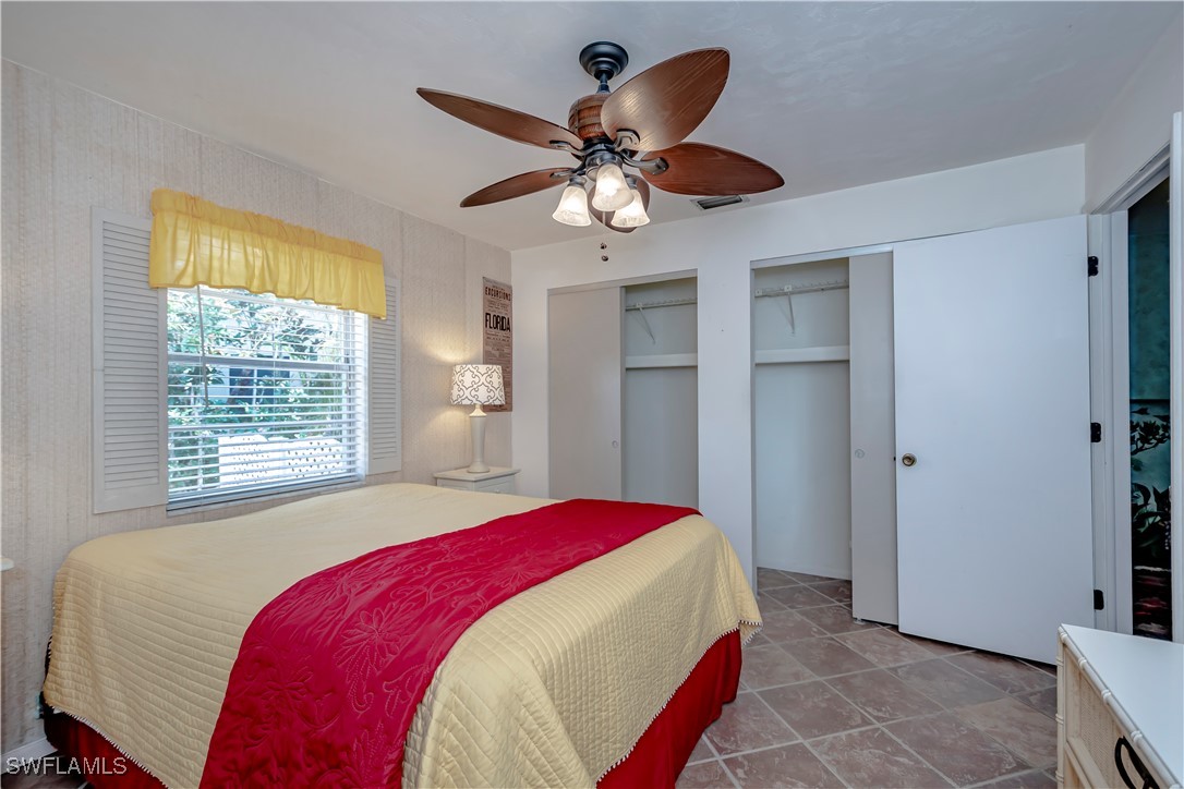 12101 Moon Shell Drive Matlacha Isles, FL 33991 - Photo 18 of 42 a bedroom with a bed and a chandelier