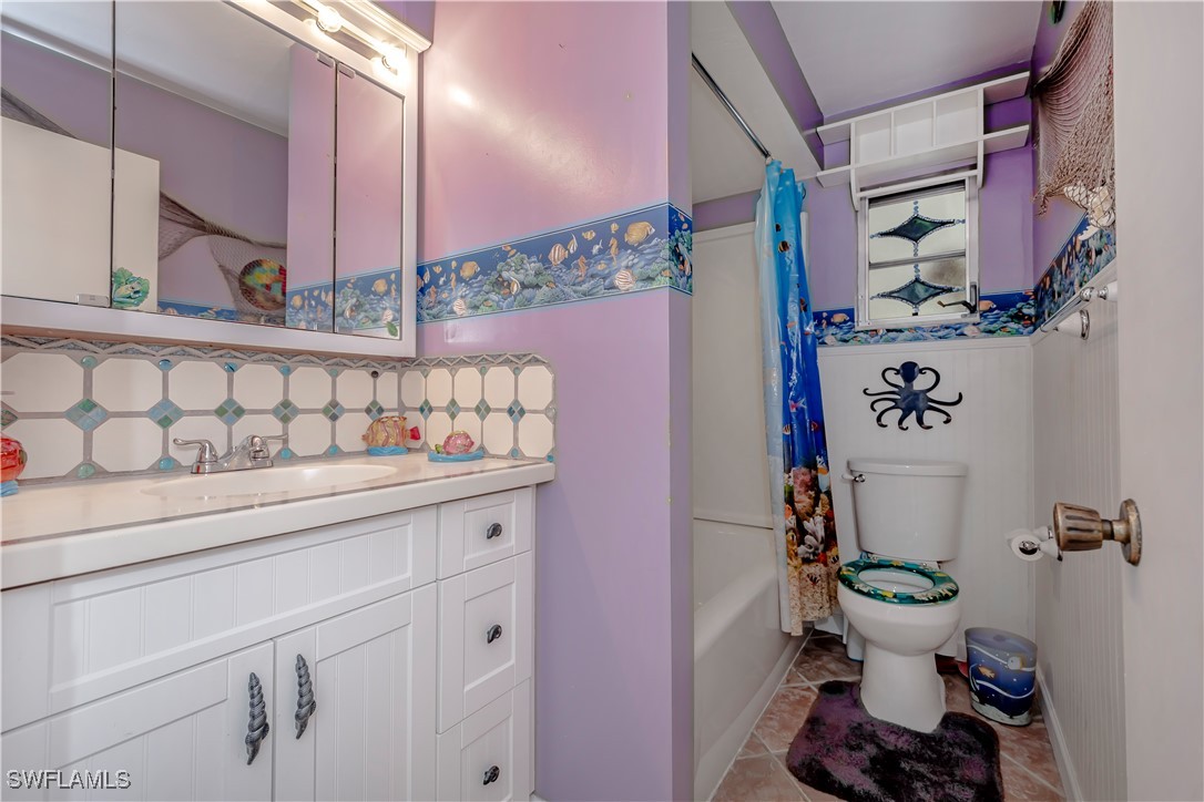 12101 Moon Shell Drive Matlacha Isles, FL 33991 - Photo 19 of 42 a bathroom with a sink toilet and a mirror