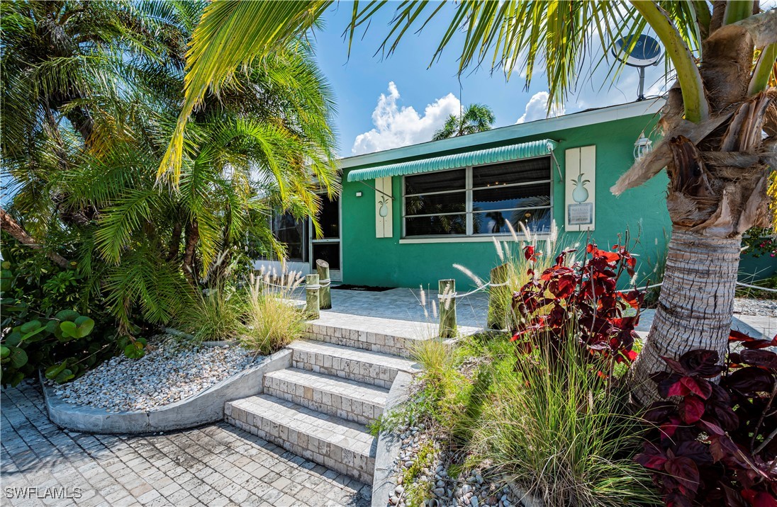 12101 Moon Shell Drive Matlacha Isles, FL 33991 - Photo 36 of 42 a front view of a house with a yard