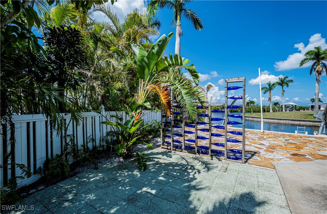 12101 Moon Shell Drive Matlacha Isles, FL 33991 - Photo 37 of 42 a view of a chairs and table in a backyard