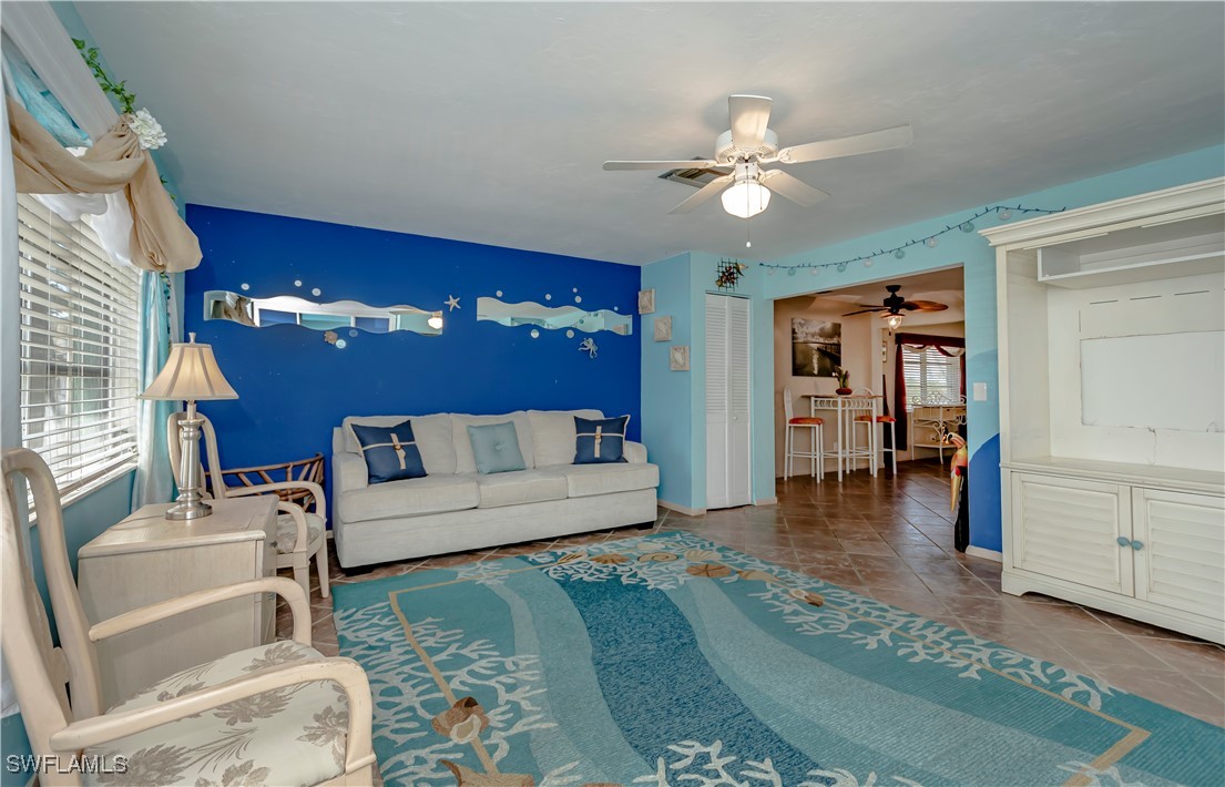 12101 Moon Shell Drive Matlacha Isles, FL 33991 - Photo 8 of 42 a living room with furniture and a chandelier