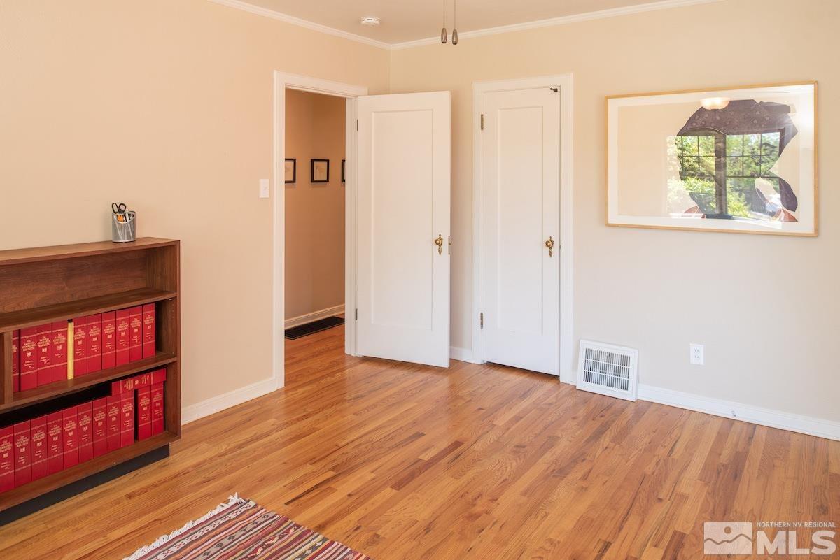 895 Lander Street Reno, NV 89509 - Photo 11 of 38 a view of an empty room with wooden floor and a window