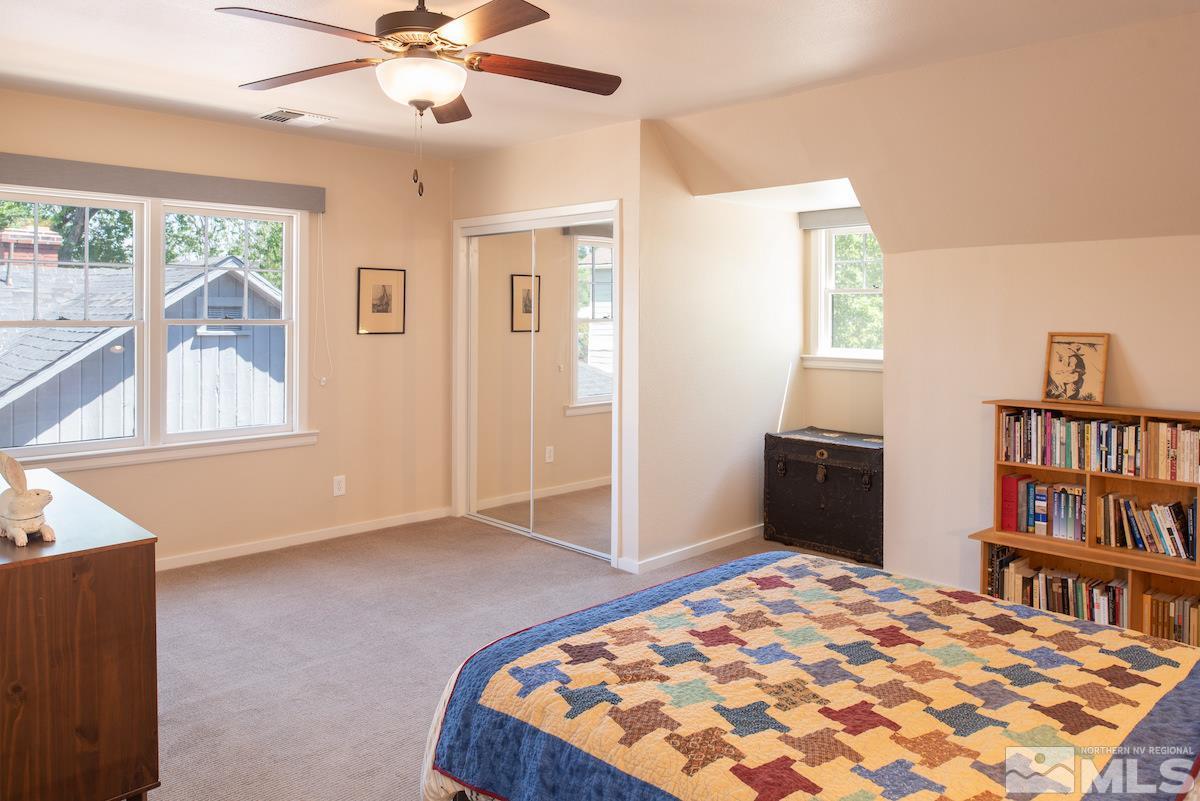 895 Lander Street Reno, NV 89509 - Photo 13 of 38 a bedroom with a bed and a book shelf