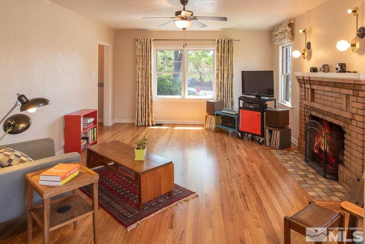 895 Lander Street Reno, NV 89509 - Photo 5 of 38 a living room with furniture a flat screen tv and a fireplace