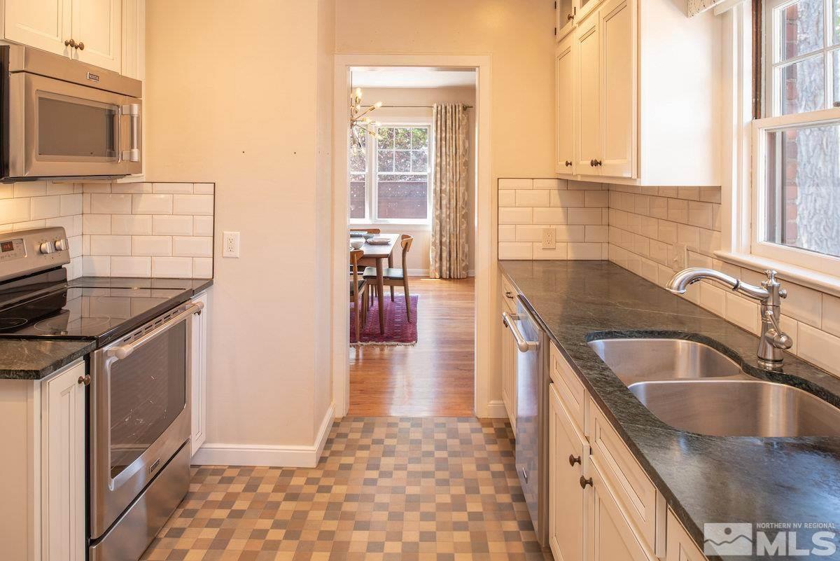 895 Lander Street Reno, NV 89509 - Photo 7 of 38 a kitchen with granite countertop a sink stove and cabinets