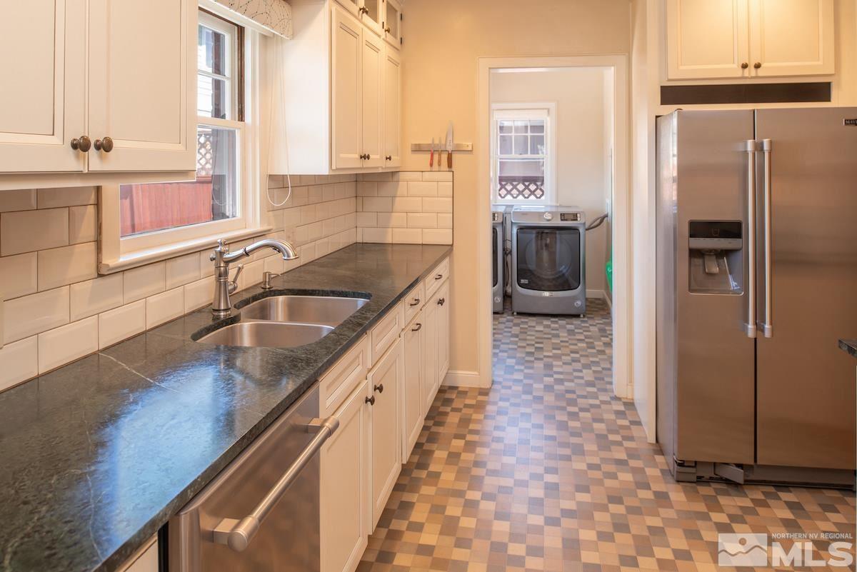 895 Lander Street Reno, NV 89509 - Photo 8 of 38 a kitchen with granite countertop a sink and a refrigerator