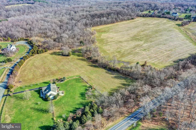 a view of a swimming pool with a yard