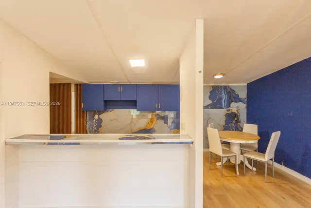 a kitchen with a table and chairs in it