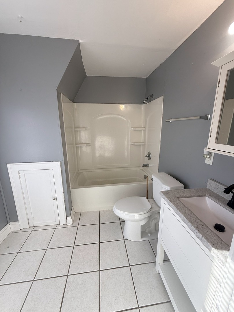 617 West Lincoln Way Morrison, IL 61270 - Photo 14 of 21 a bathroom with a sink a toilet and shower