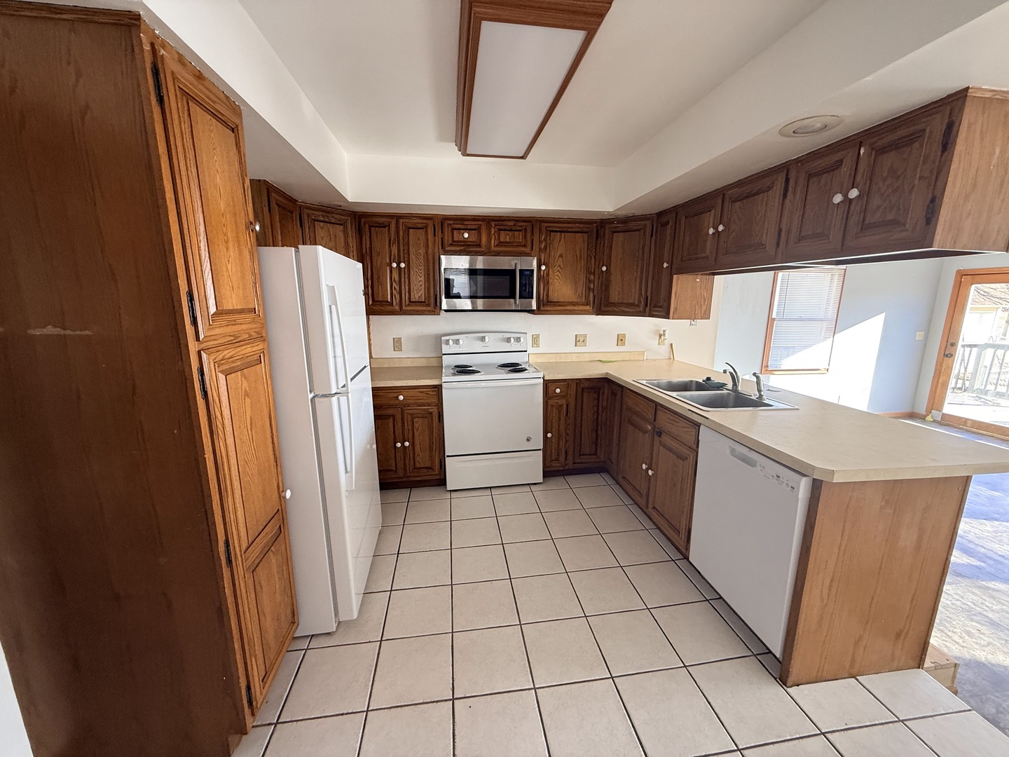 617 West Lincoln Way Morrison, IL 61270 - Photo 6 of 21 a kitchen with a sink a refrigerator and cabinets
