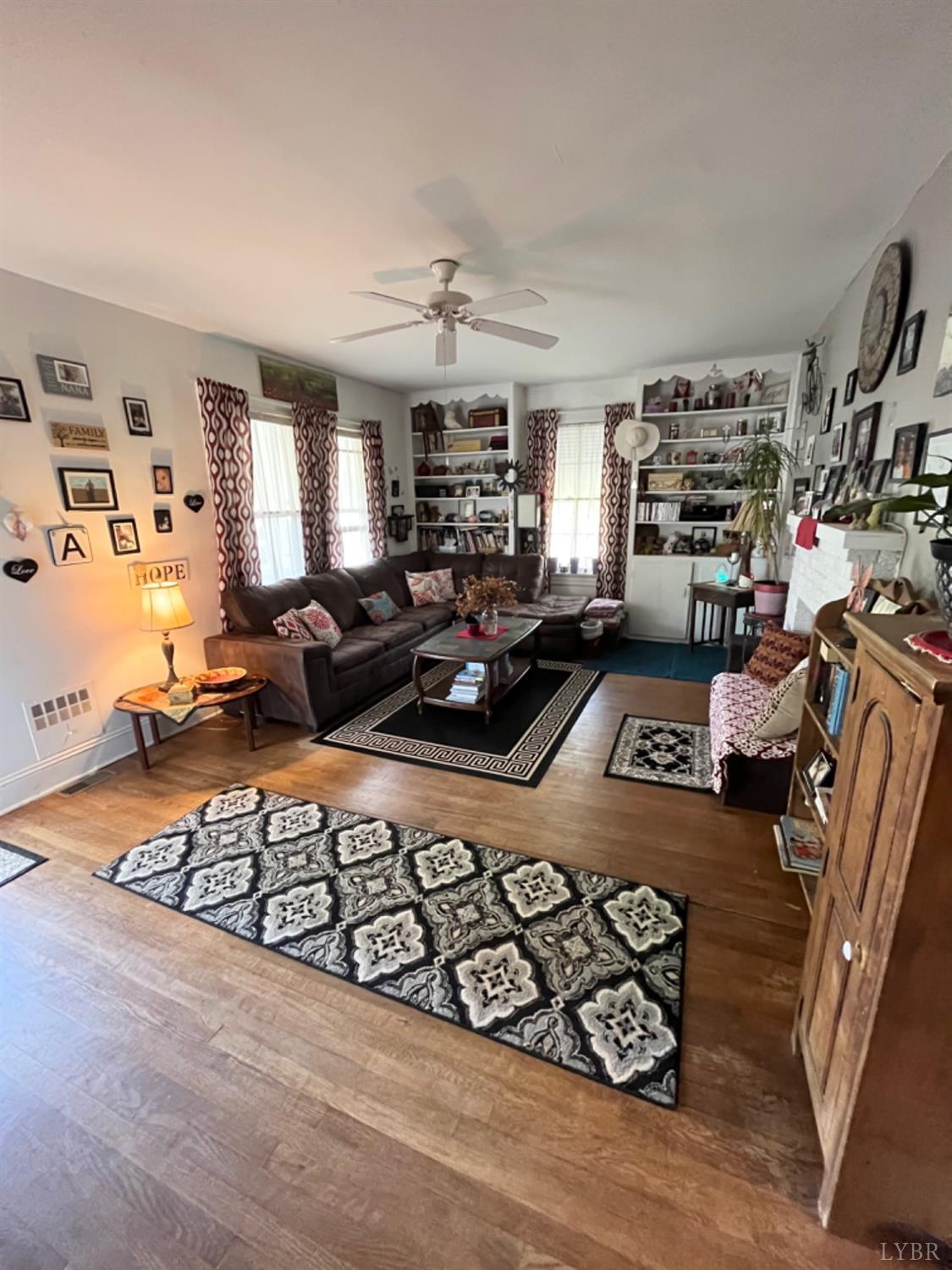 165 Cedar Gate Road Monroe, VA 24574 - Photo 18 of 37 a living room with furniture a fireplace and a large window