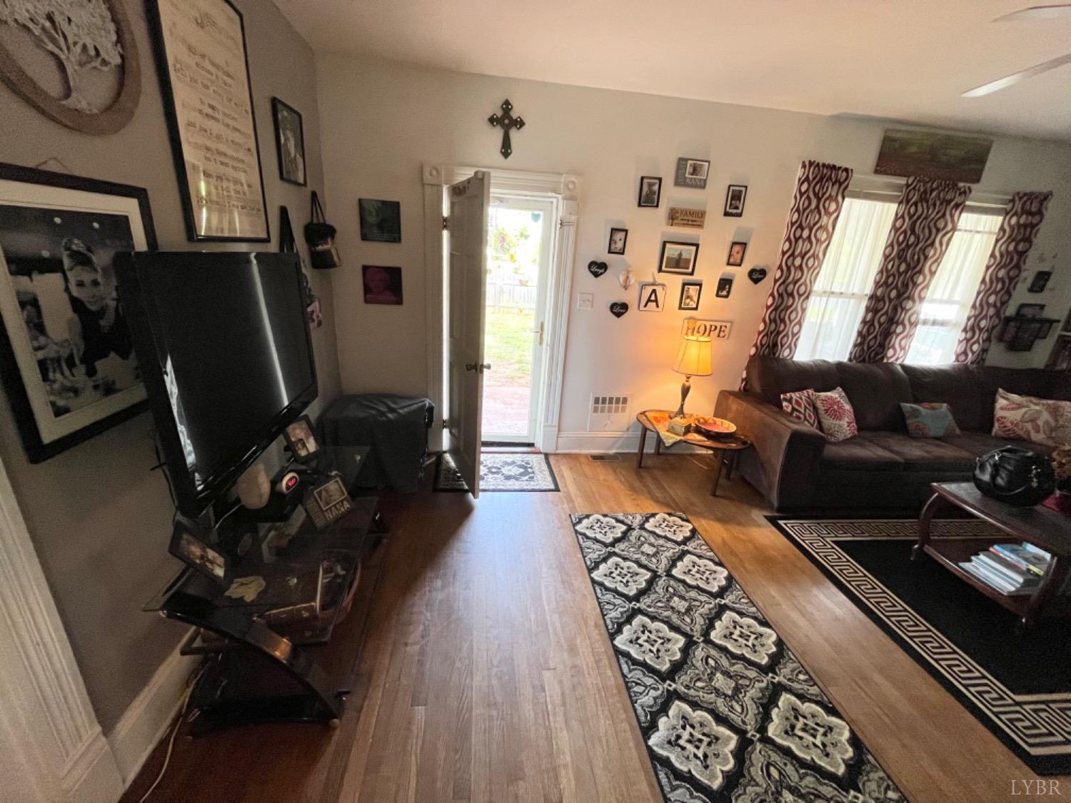 165 Cedar Gate Road Monroe, VA 24574 - Photo 19 of 37 a living room with furniture and a flat screen tv
