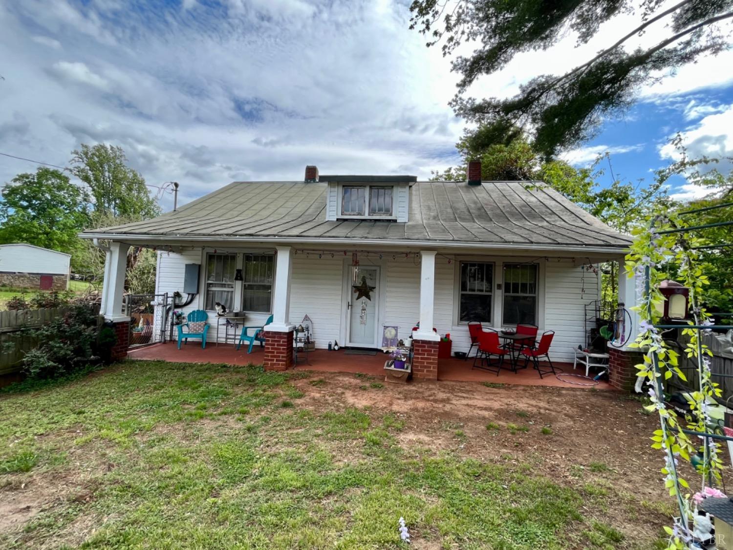 165 Cedar Gate Road Monroe, VA 24574 - Photo 2 of 37 a view of a house with backyard sitting area and garden