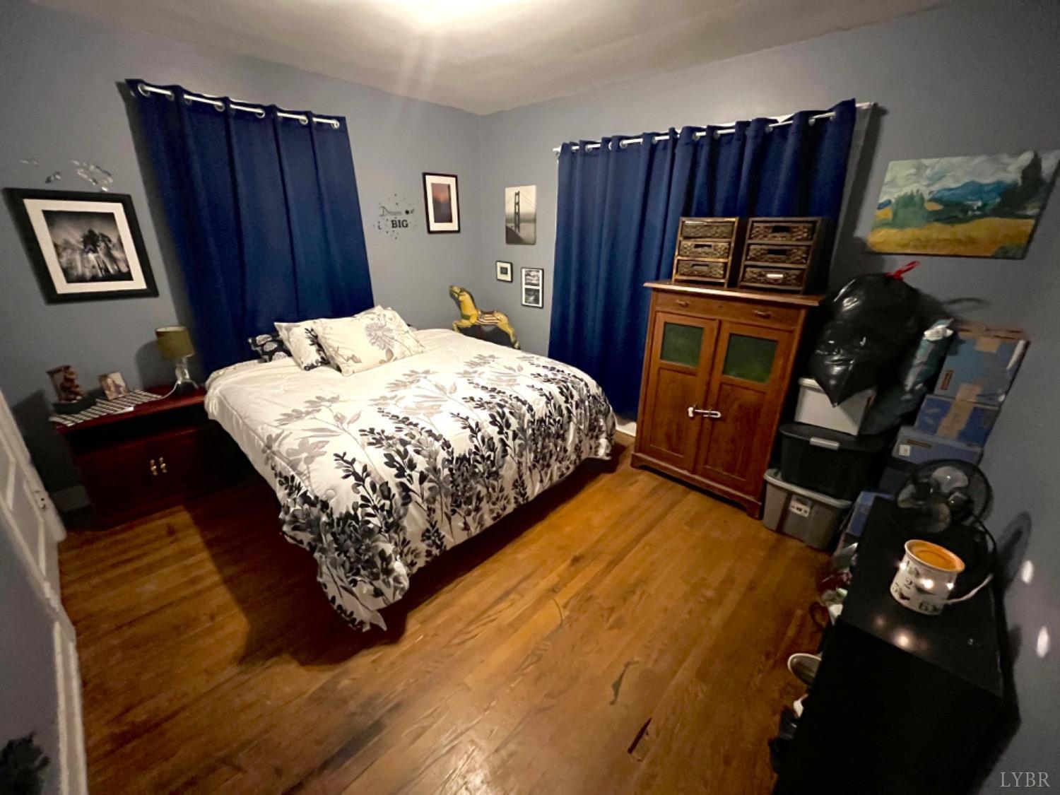 165 Cedar Gate Road Monroe, VA 24574 - Photo 24 of 37 a bed sitting in a bedroom next to a cabinet