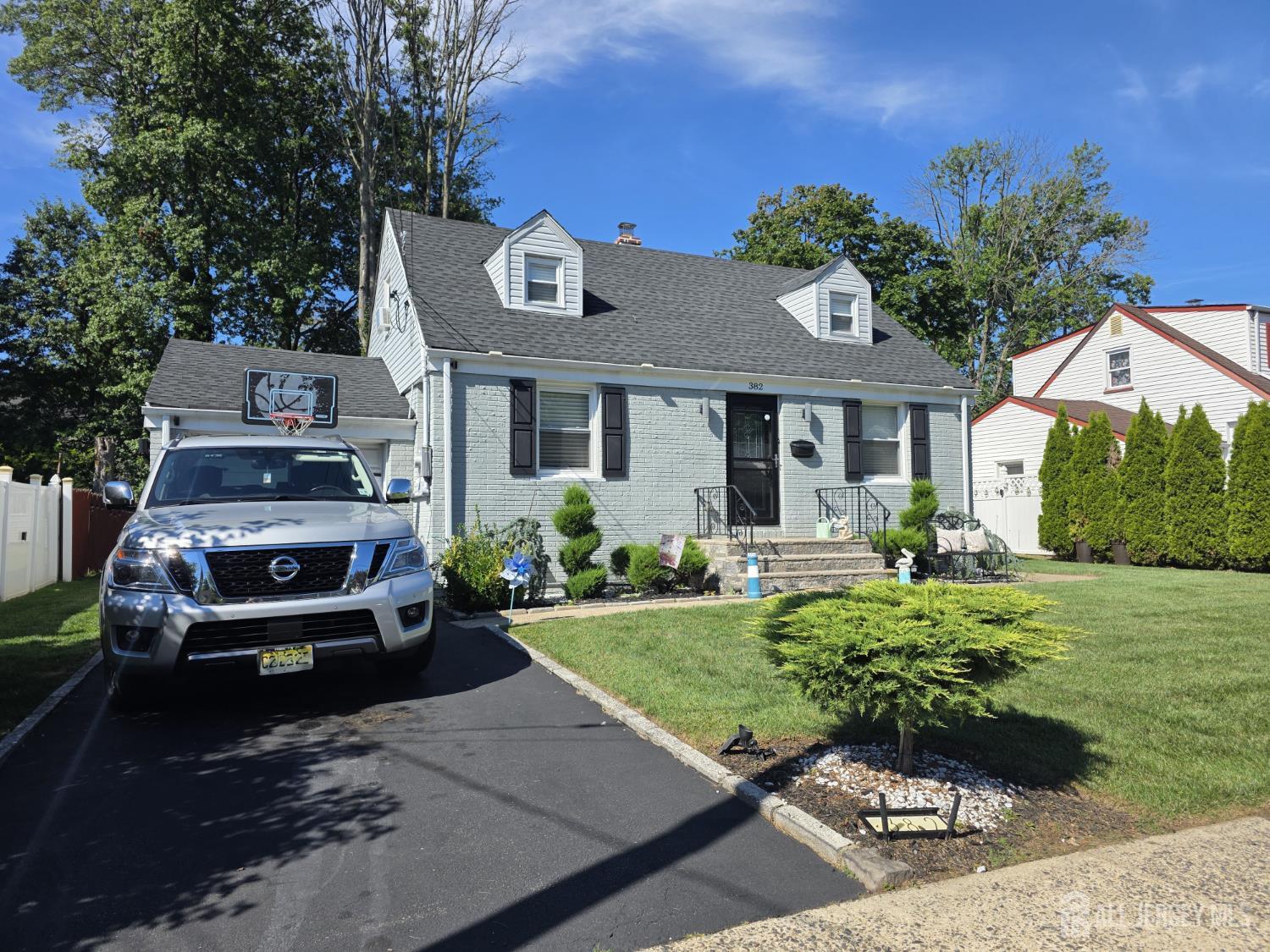 a front view of a house with a garden