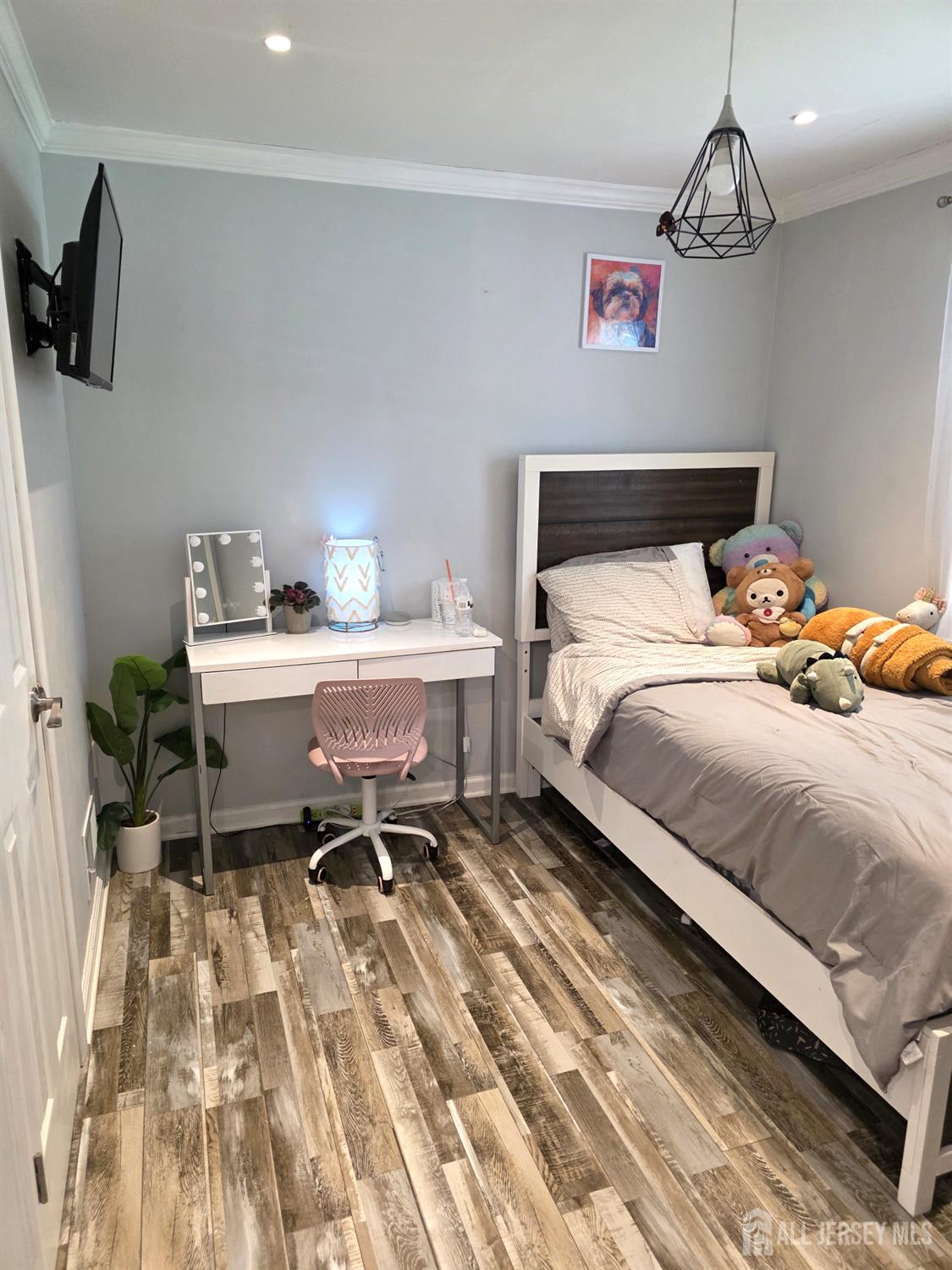 382 Douglas Road Roselle, NJ 07203 - Photo 11 of 17 a bedroom with a bed and a chandelier