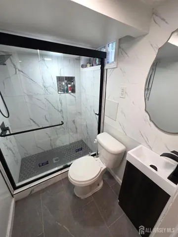 a bathroom with a toilet and a shower