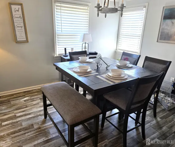 a view of a dining room with a table and chairs