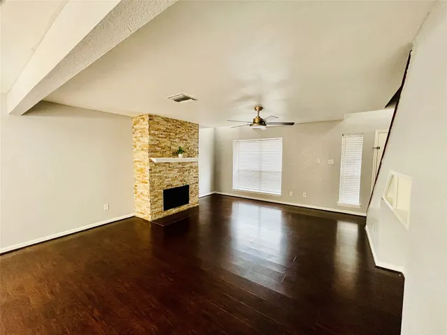 wooden floor in an empty room with a fireplace