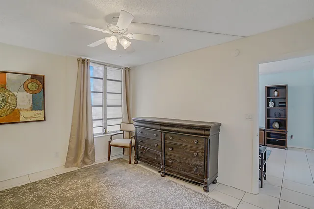 a view of an empty room with cabinet and a window