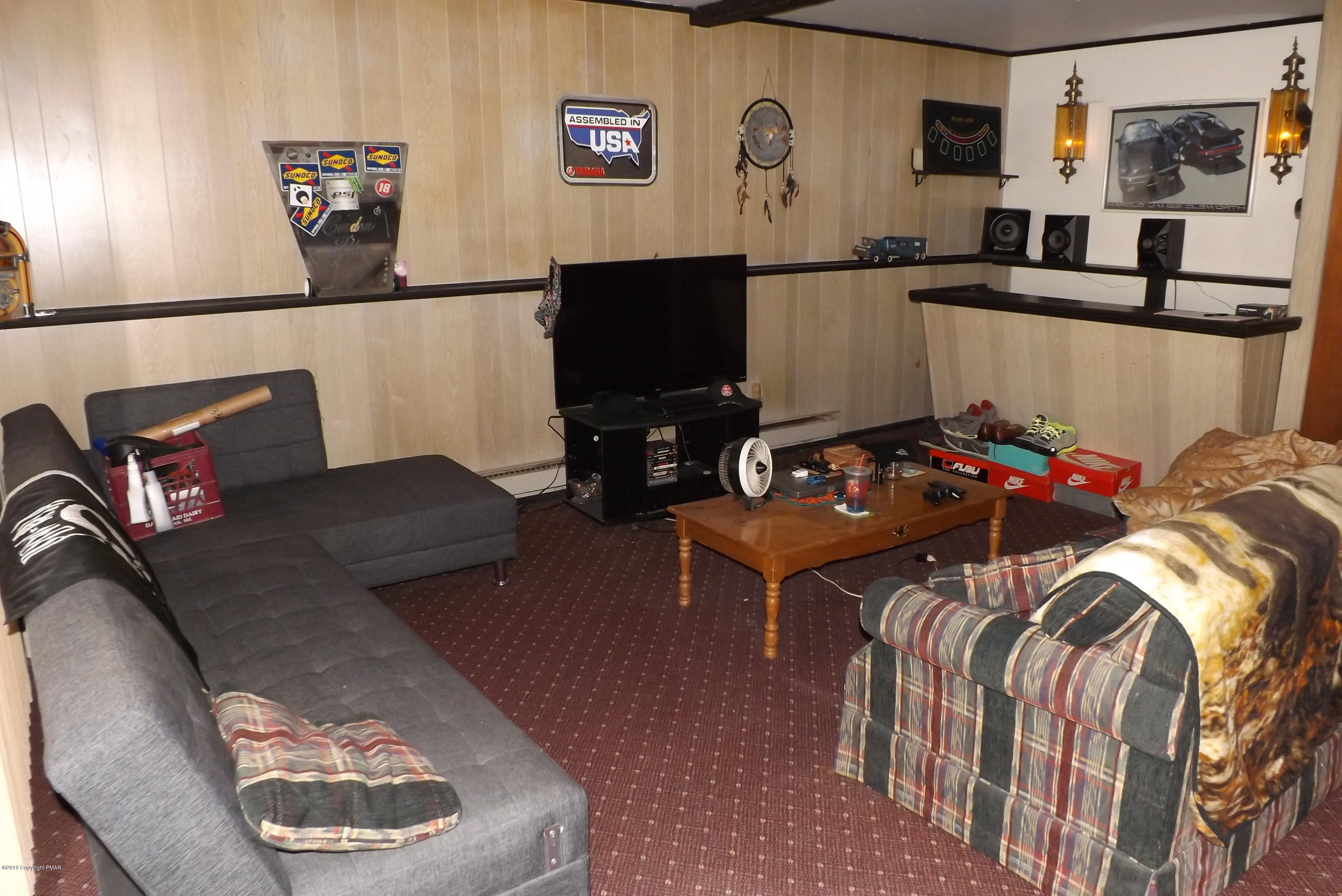 122 Maple Road Blakeslee, PA 18610 - Photo 20 of 37 a living room with furniture and a flat screen tv