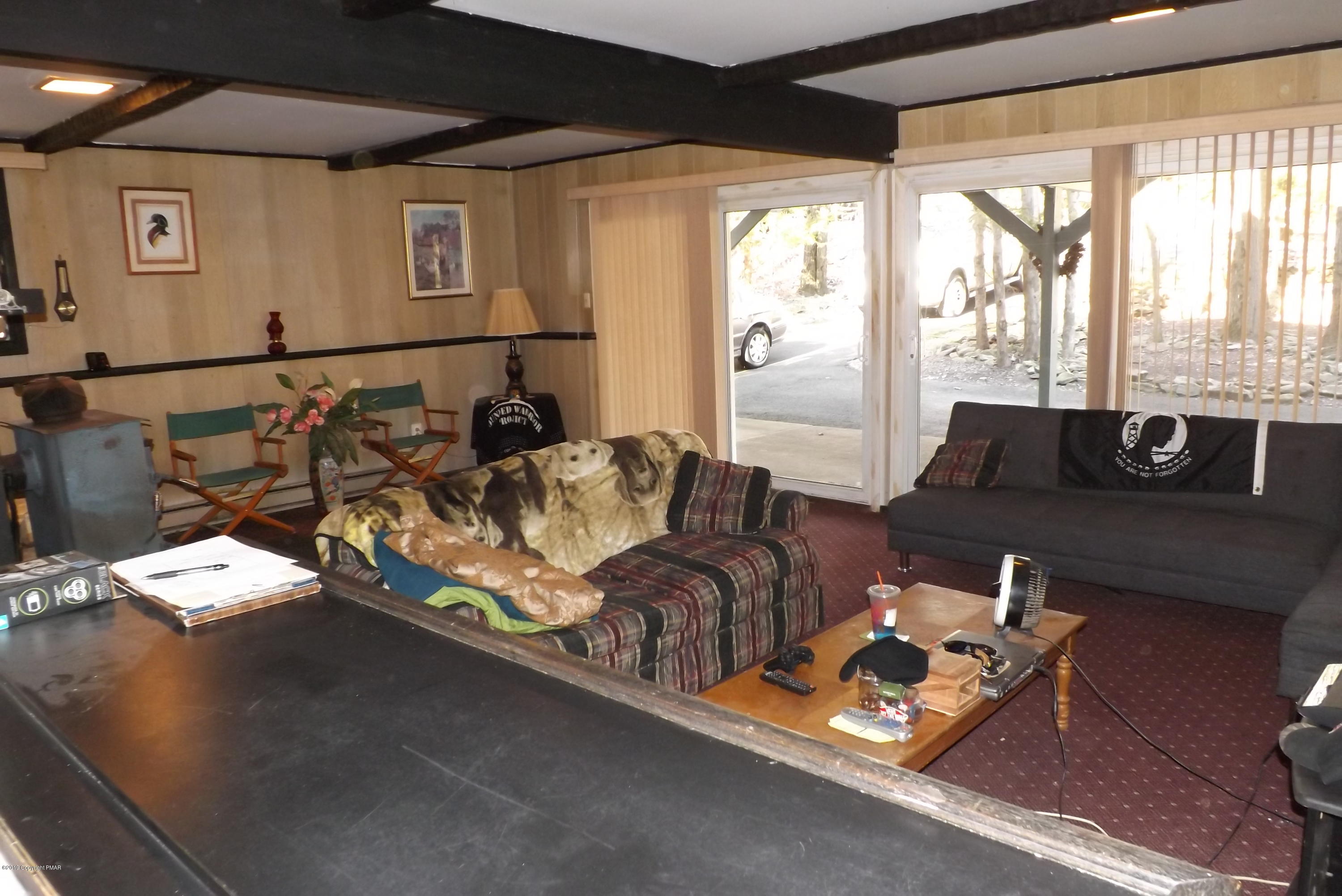 122 Maple Road Blakeslee, PA 18610 - Photo 22 of 37 a living room with furniture and floor to ceiling window