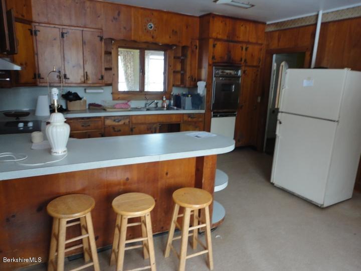 11 Albany Road West Stockbridge, MA 01266 - Photo 8 of 39 a kitchen with stainless steel appliances granite countertop a refrigerator and microwave