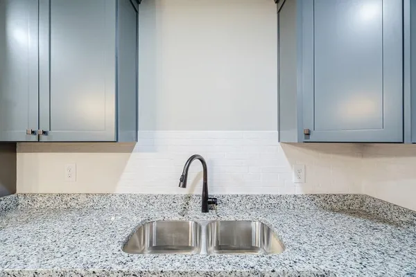 a kitchen with kitchen island stainless steel appliances a wooden floor