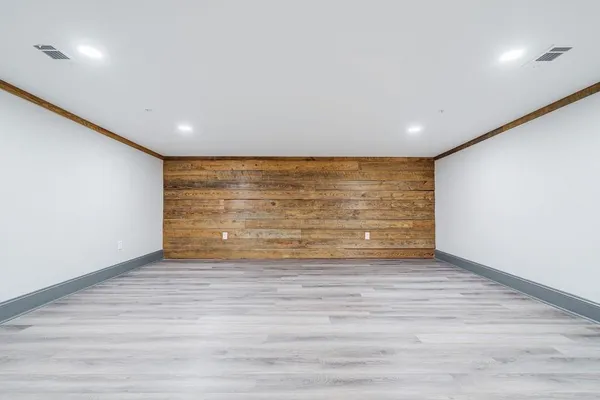 a large kitchen with stainless steel appliances granite countertop a refrigerator a stove a sink dishwasher and a oven with wooden floor