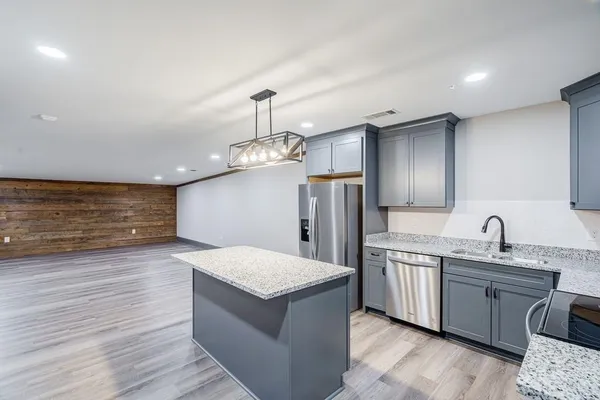 a kitchen with stainless steel appliances granite countertop a sink stove and refrigerator