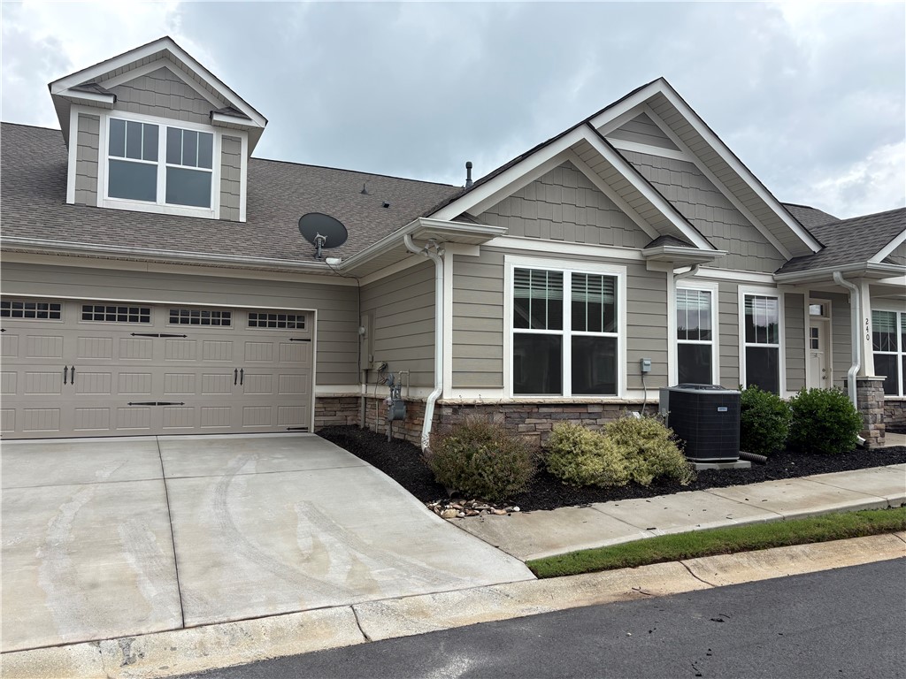 240 Meridian Way Seneca, SC 29672 - Photo 3 of 19 A welcoming facade with a clean driveway and mature landscaping.