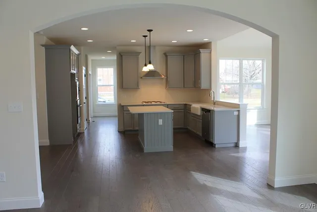 a view of a kitchen with a sink and wooden floor