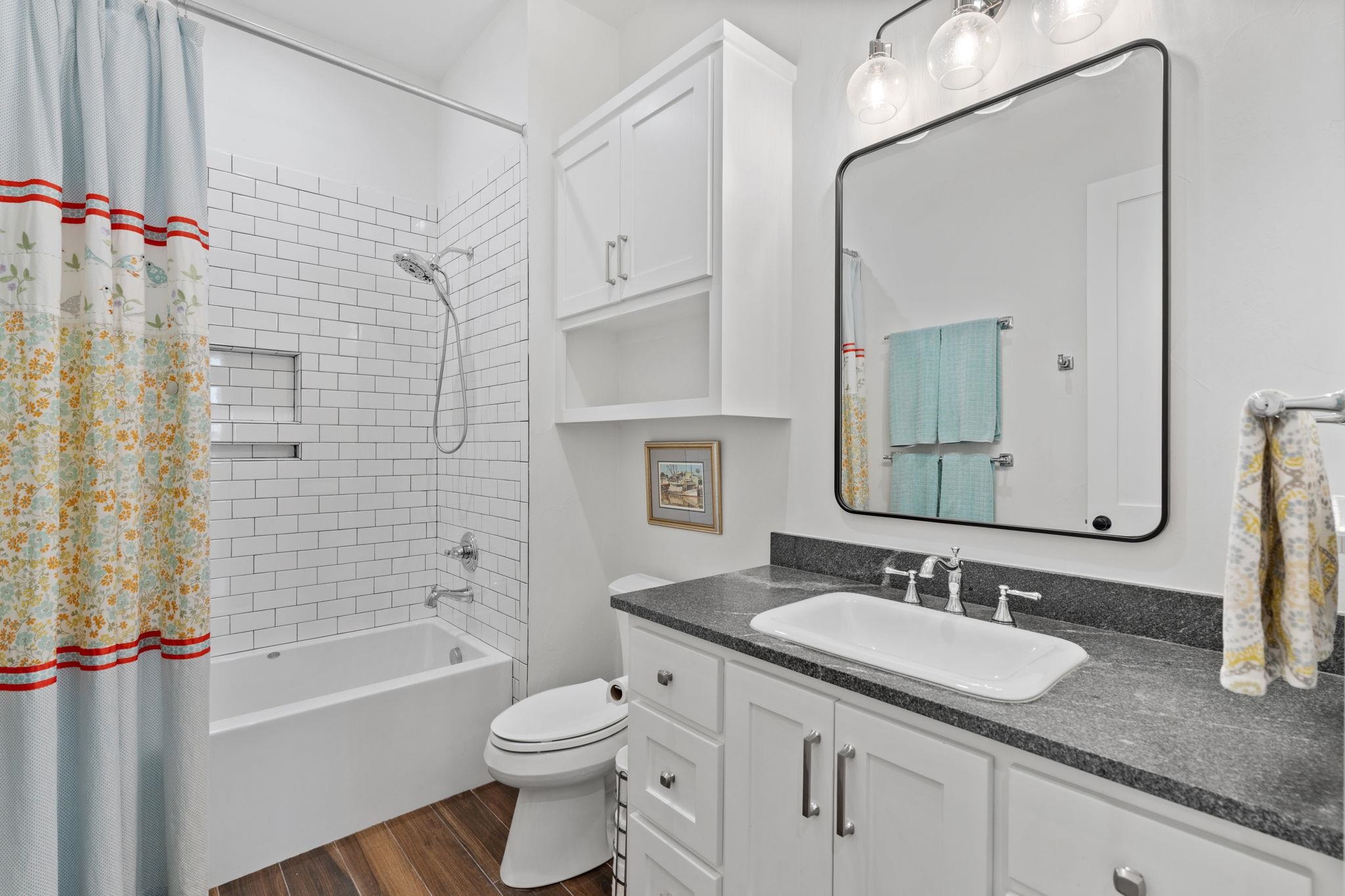 452 Southwick Ranch Road Johnson City, TX 78636 - Photo 24 of 44 a bathroom with a granite countertop sink toilet and shower