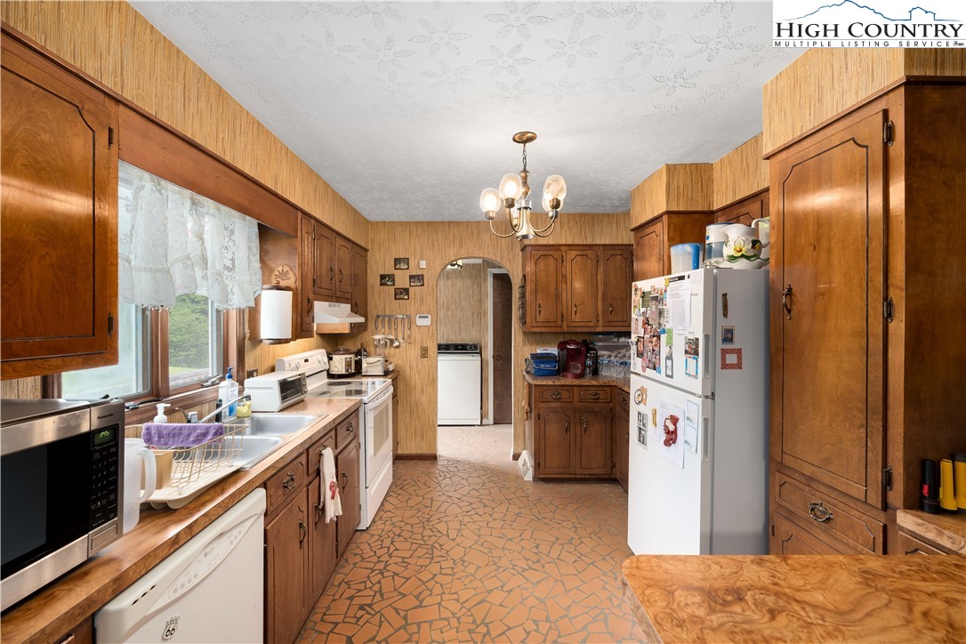 1546 Stage Road Mountain City, TN 37683 - Photo 13 of 48 a kitchen with refrigerator and cabinets