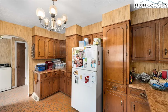 a kitchen with appliances a sink and cabinets
