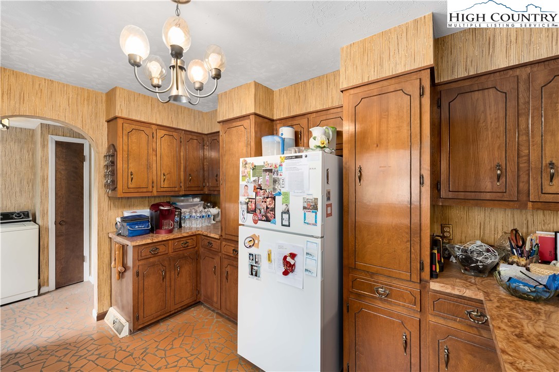 1546 Stage Road Mountain City, TN 37683 - Photo 14 of 48 a kitchen with stainless steel appliances a refrigerator and a chandelier