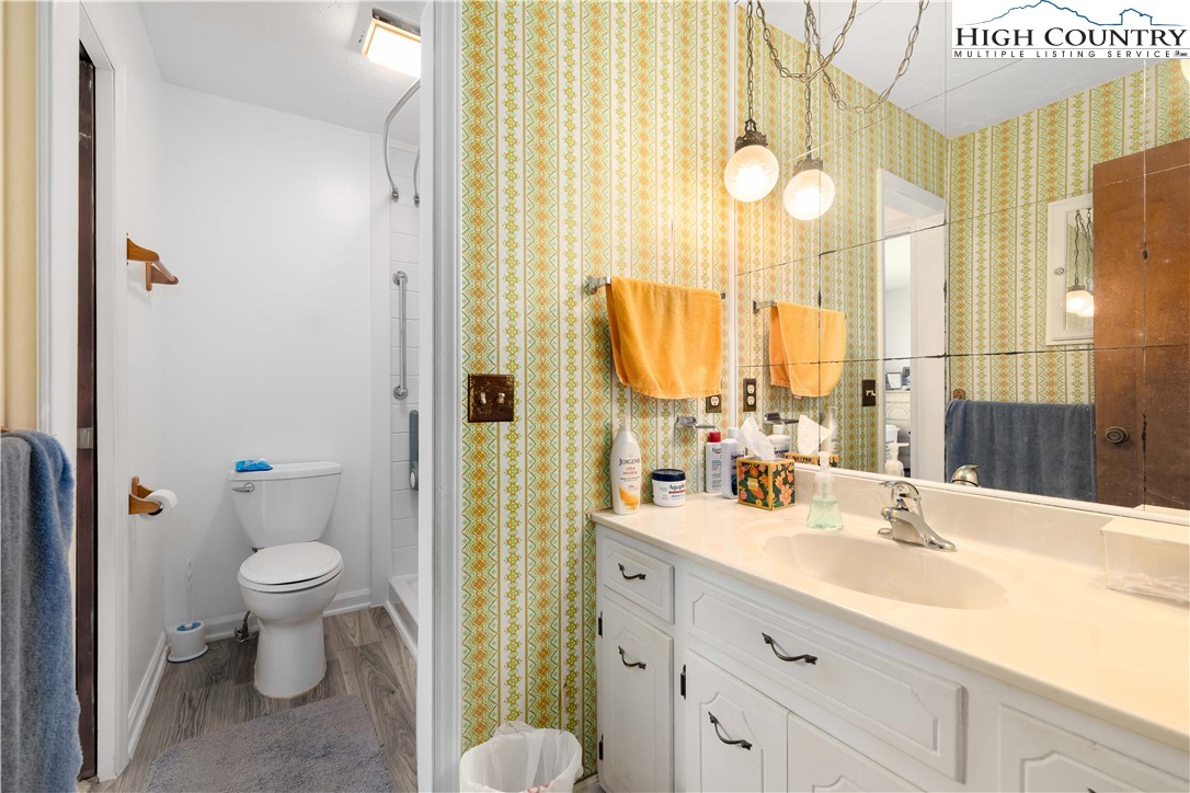 1546 Stage Road Mountain City, TN 37683 - Photo 21 of 48 a bathroom with a double vanity sink toilet and a mirror