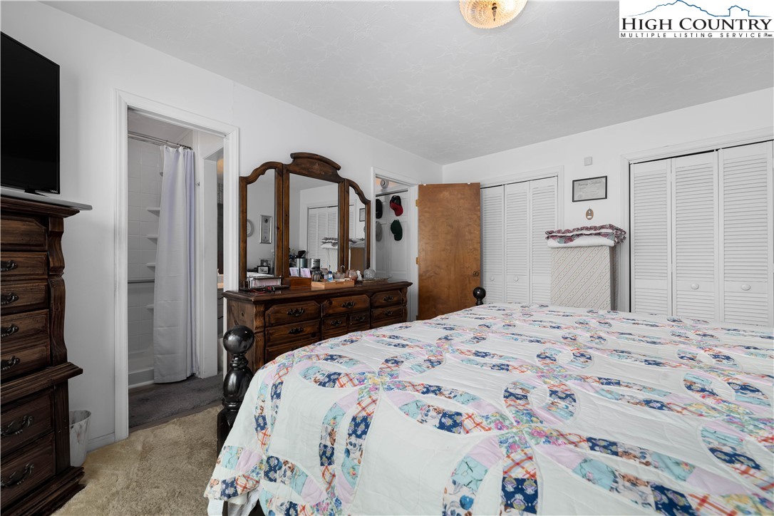 1546 Stage Road Mountain City, TN 37683 - Photo 23 of 48 a bedroom with a bed and a flat screen tv in it