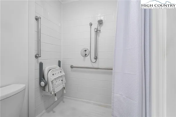 a bedroom with a bed and a television