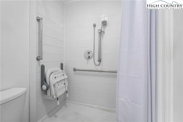 a bedroom with a bed and a television