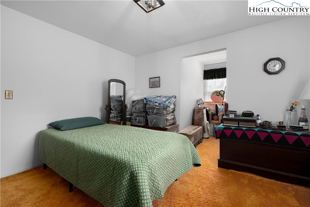 1546 Stage Road Mountain City, TN 37683 - Photo 27 of 48 a bedroom with a bed and a table