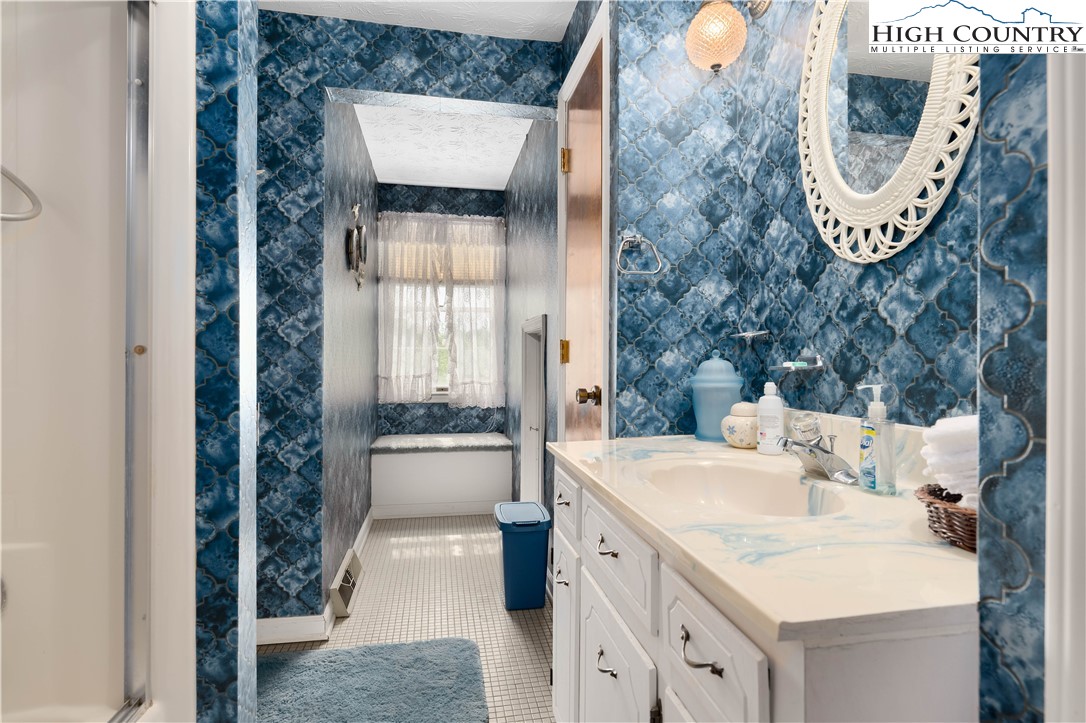 1546 Stage Road Mountain City, TN 37683 - Photo 28 of 48 a bathroom with a sink a toilet and a mirror